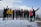 A group of travelers smiling with snow-capped peaks of Gulmarg in the background.