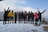 A group of travelers smiling with snow-capped peaks of Gulmarg in the background.