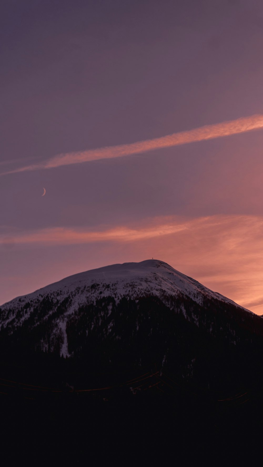 a mountain with a sunset in the background