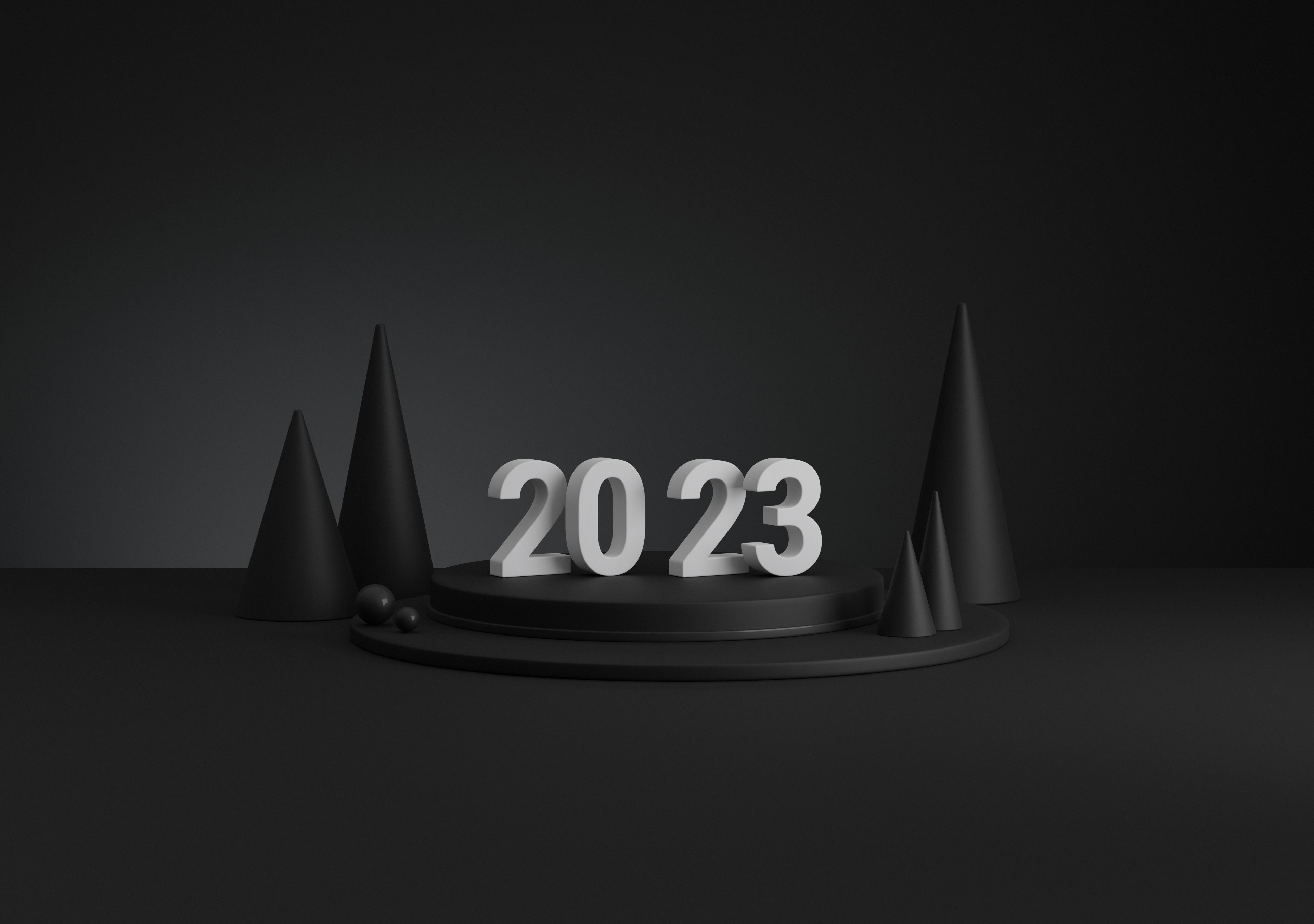3d render of minimalistic matte black podium with 2023 type on top in addition to spheres and cones scattered around and matte black background, lit with 2 soft light sources.
