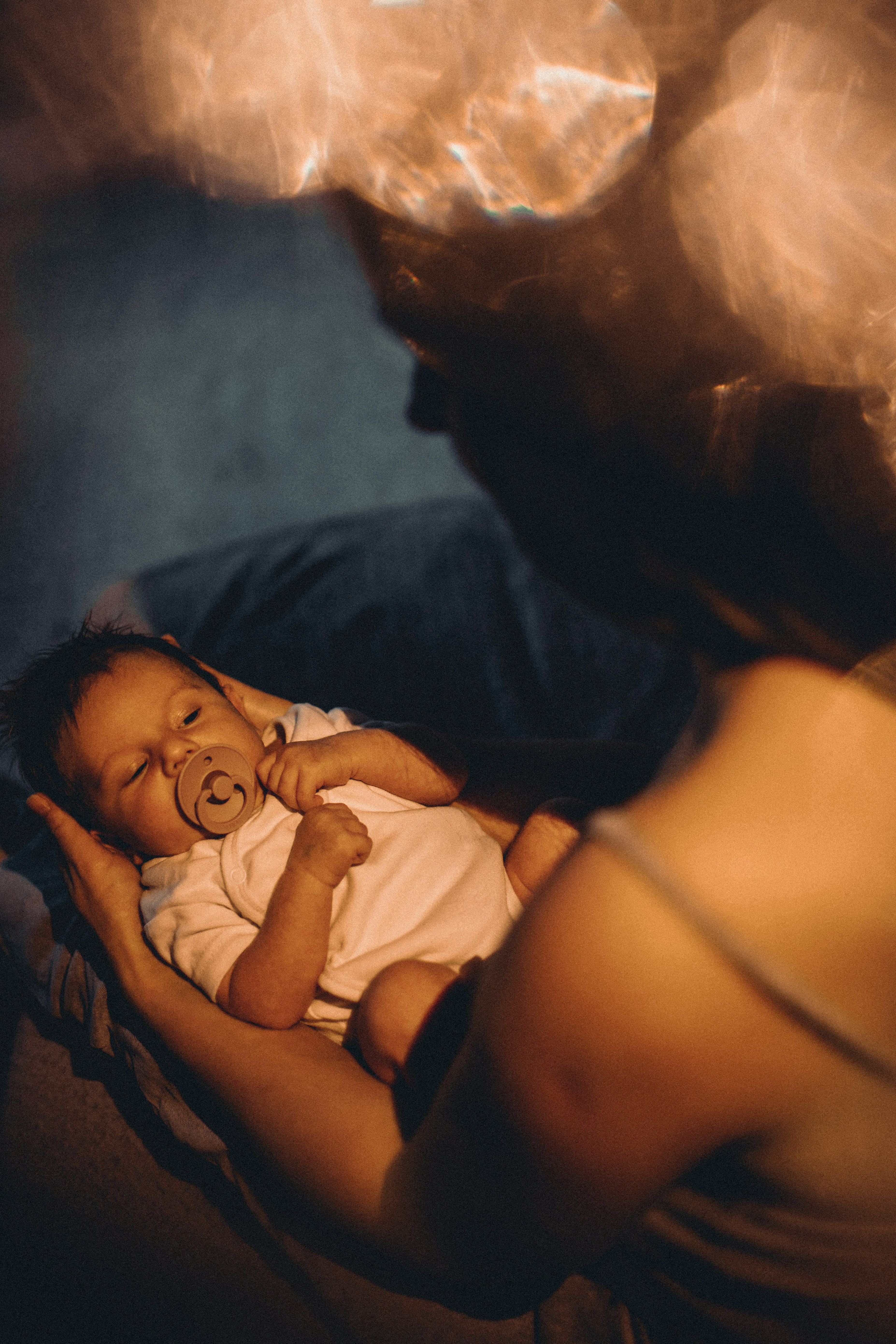 Newborn baby lying peacefully in a warm cozy setting