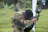Players in camouflage gear aiming paintball guns on a vibrant outdoor field in Hannover.