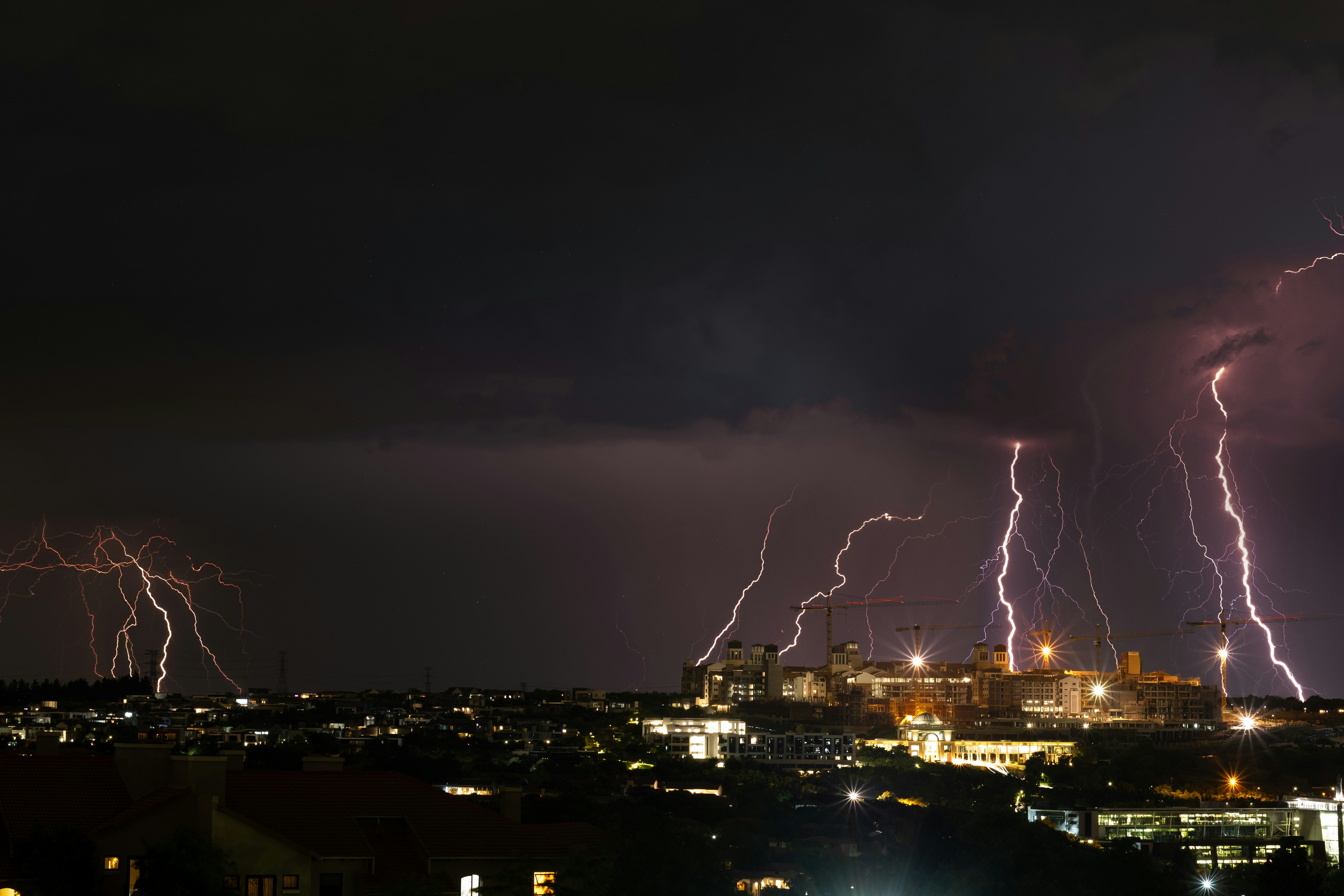 a city with lightning striking the ground