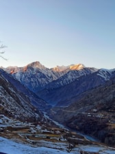 A scenic mountain valley in northern Pakistan bathed in golden sunlight.