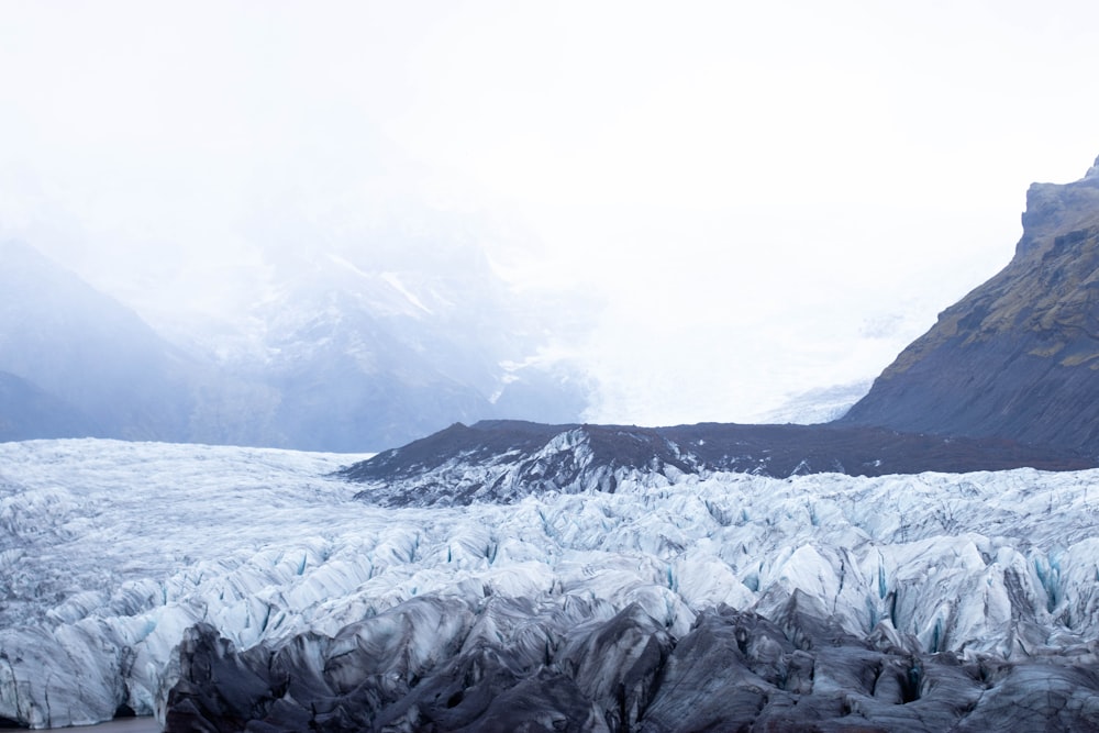 a river flowing through a snowy mountainous region