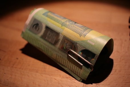 Laboratory technician carefully restoring a damaged banknote using chemical solutions.