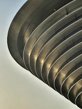 Close-up of sleek arch aluminum frame with reflective glass panels.