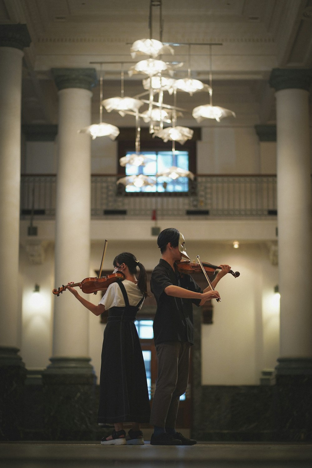 a man and woman playing violin