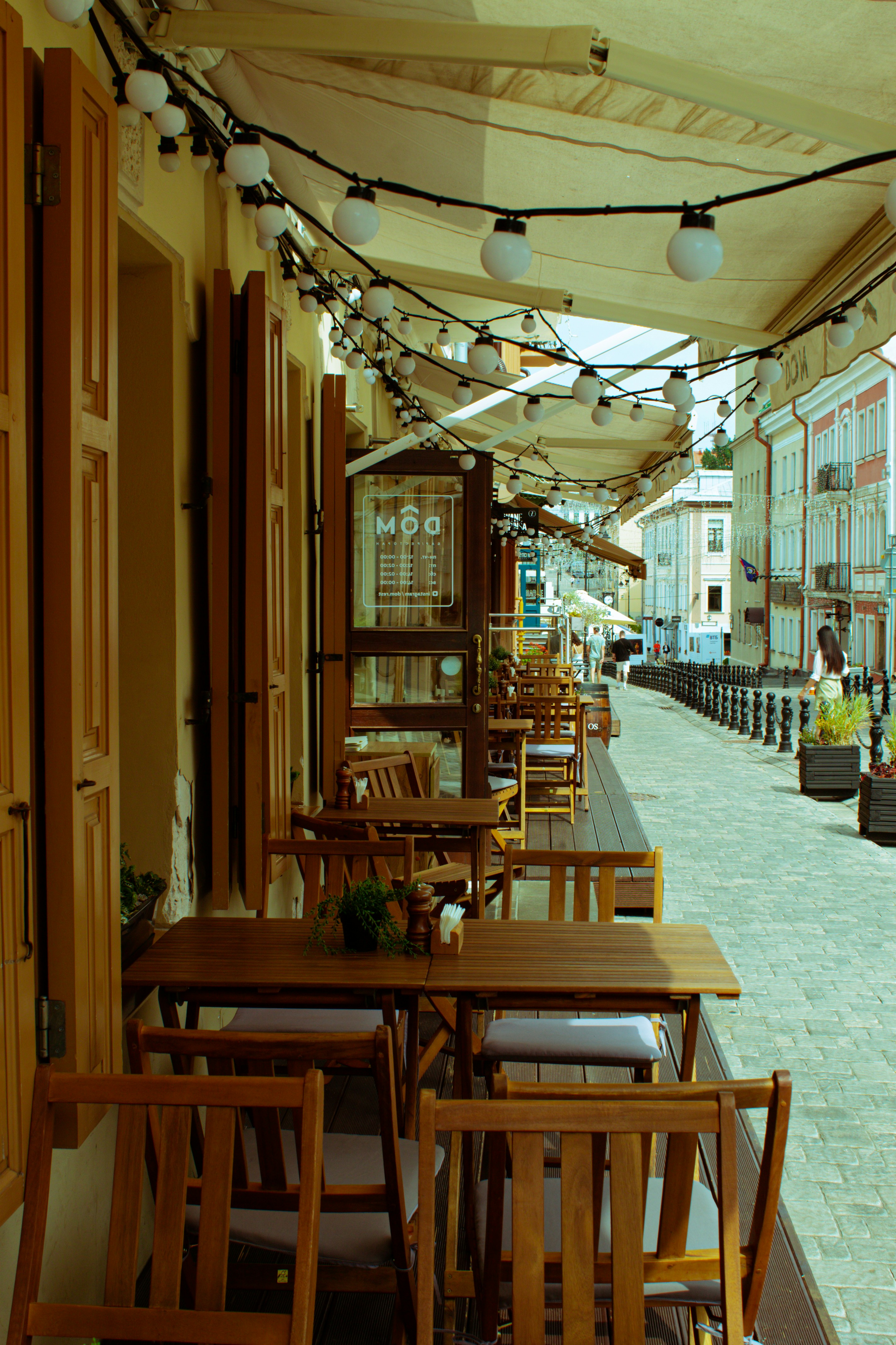 A scenic view of a European street with a cafe