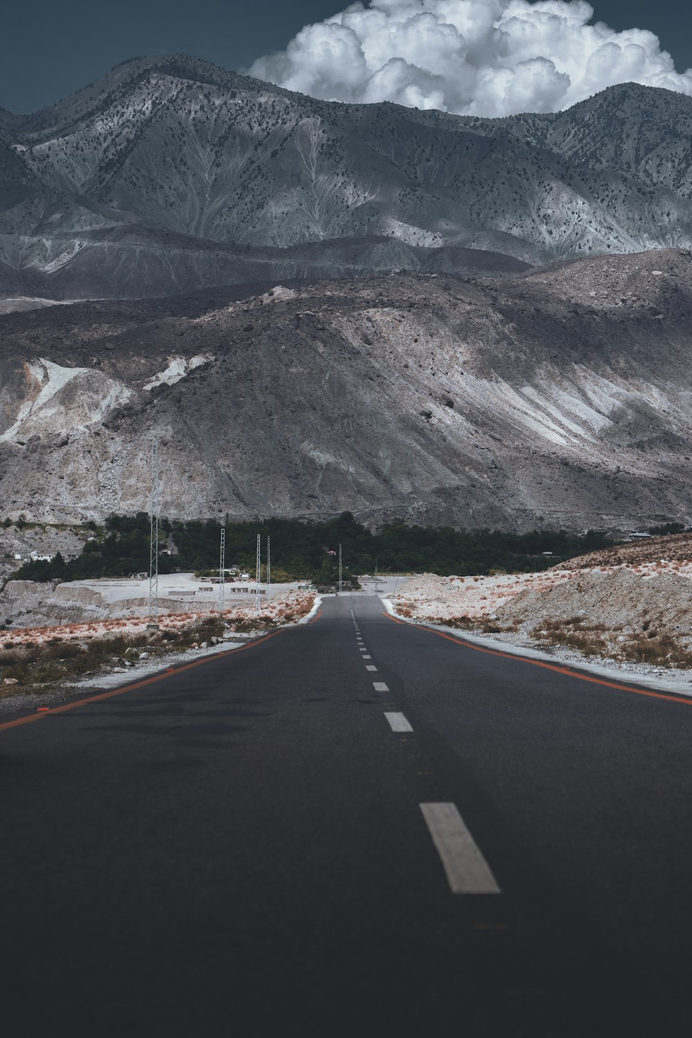 a road with mountains in the background