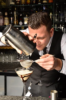 a man pouring a glass of wine