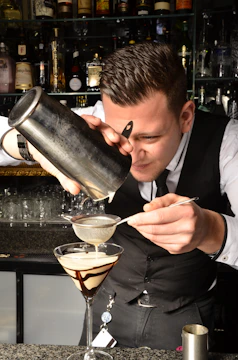 a man pouring a glass of wine