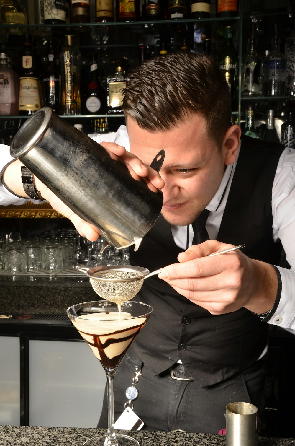 a man pouring a glass of wine