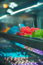 Close-up of colorful festival lights and traditional sweets displayed on shelves.