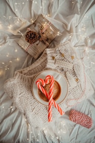 A cozy scene of people sharing warm drinks amidst falling snowflakes.