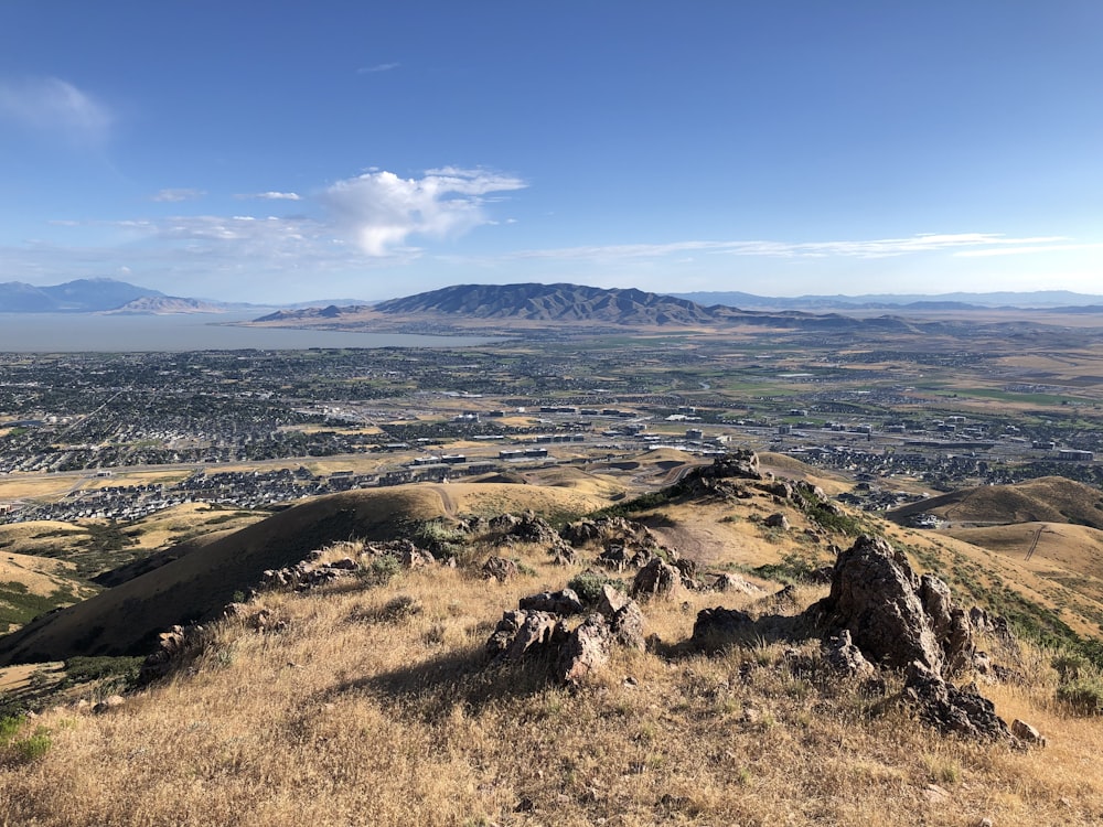 a landscape with hills and a body of water in the distance