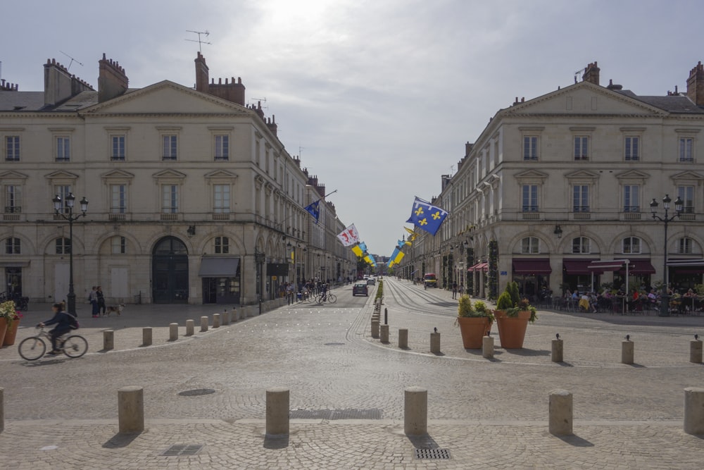 a street with buildings and a person riding a bicycle