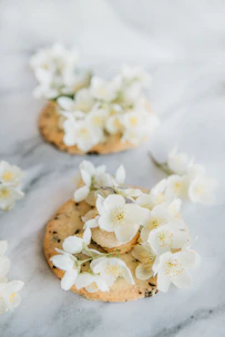 Close-up of beautifully decorated sugar cookies with delicate pastel icing and intricate floral patterns.