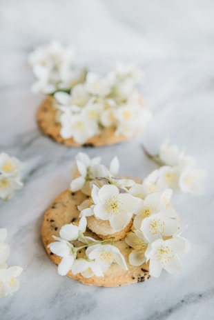 Delicate sugar cookies decorated with pastel icing flowers.