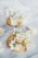 Close-up of a beautifully decorated sugar cookie with delicate pastel icing and intricate floral designs.