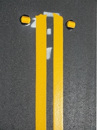 Freshly painted road lines on a highway with bright reflectivity.