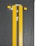 Two yellow lines on a dark asphalt road surface, with circular reflective road markers positioned between and alongside the lines.