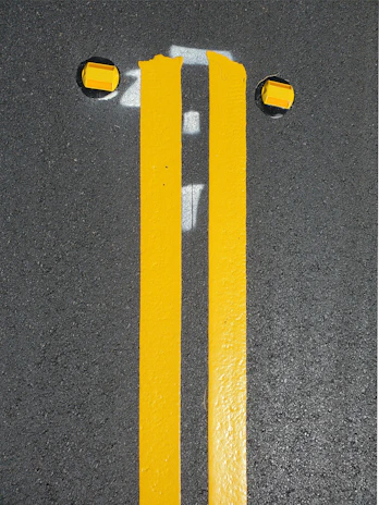 A team from Madin General Maintenance carefully applying bright yellow lines on a busy KwaZulu-Natal highway.