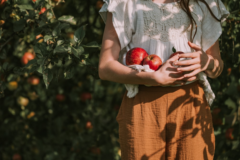 a person holding an apple