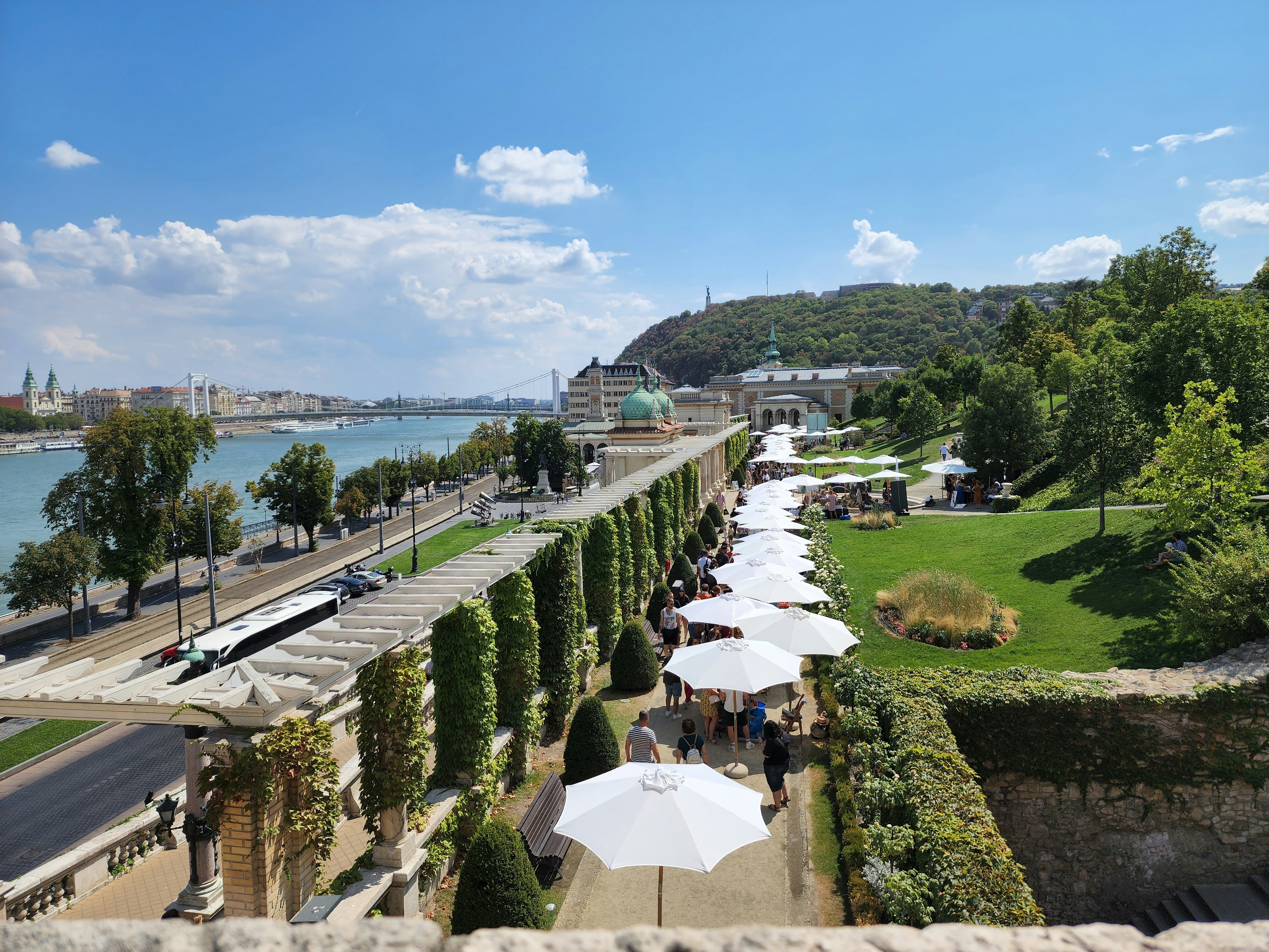 a park with a body of water and a hill with trees