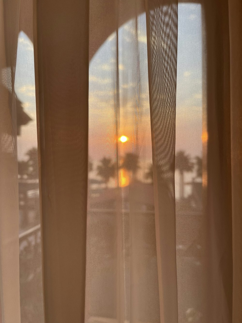 a window with a view of the sunset