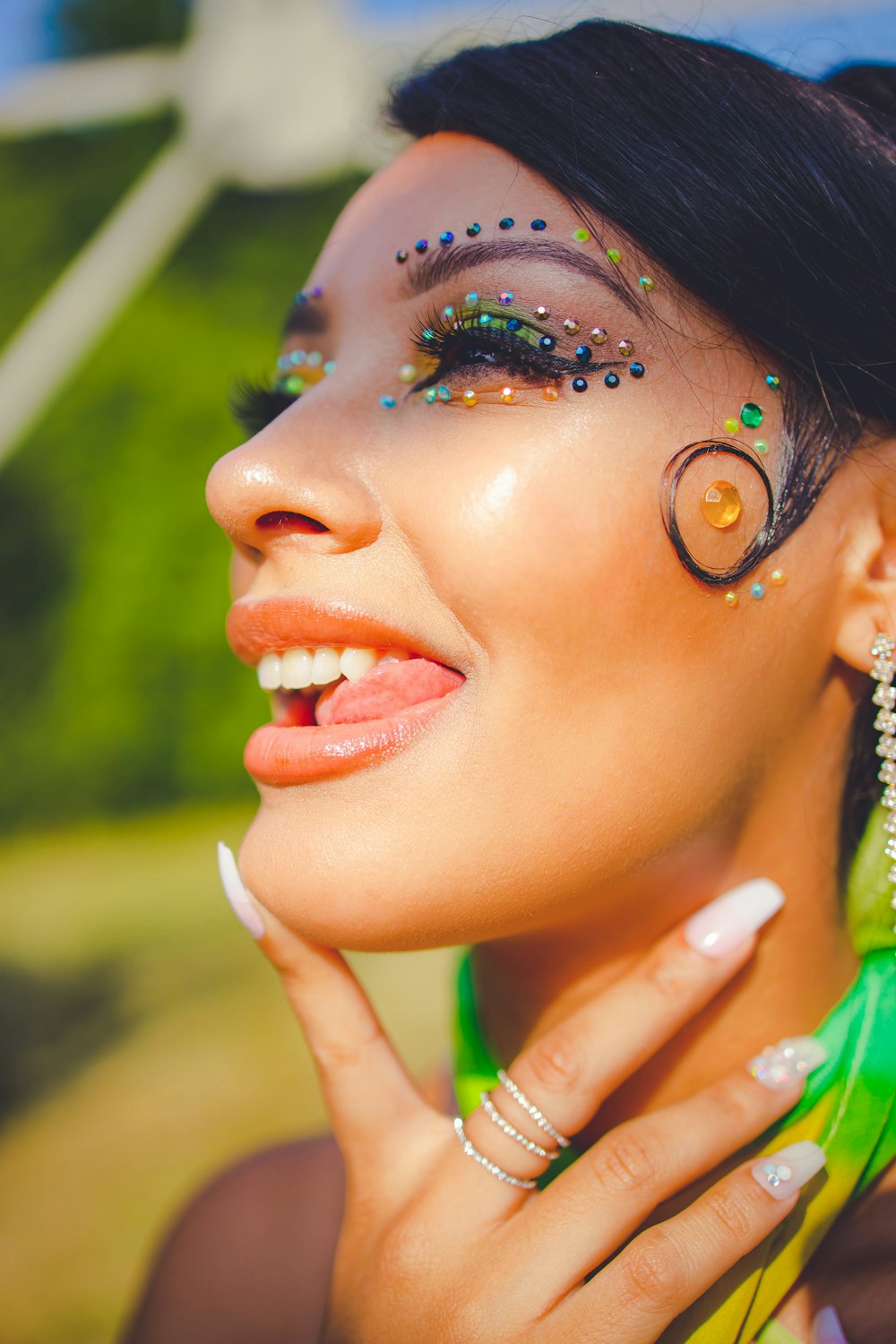 a woman with makeup and a hand on her face