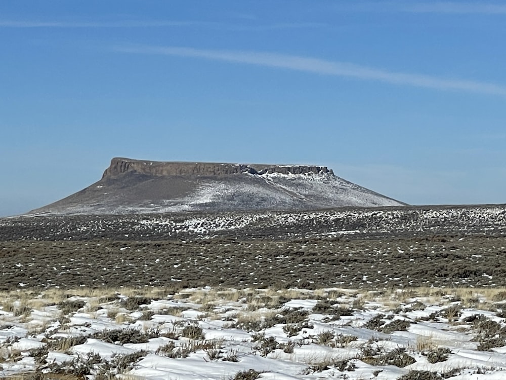 a snowy mountain with a blue sky