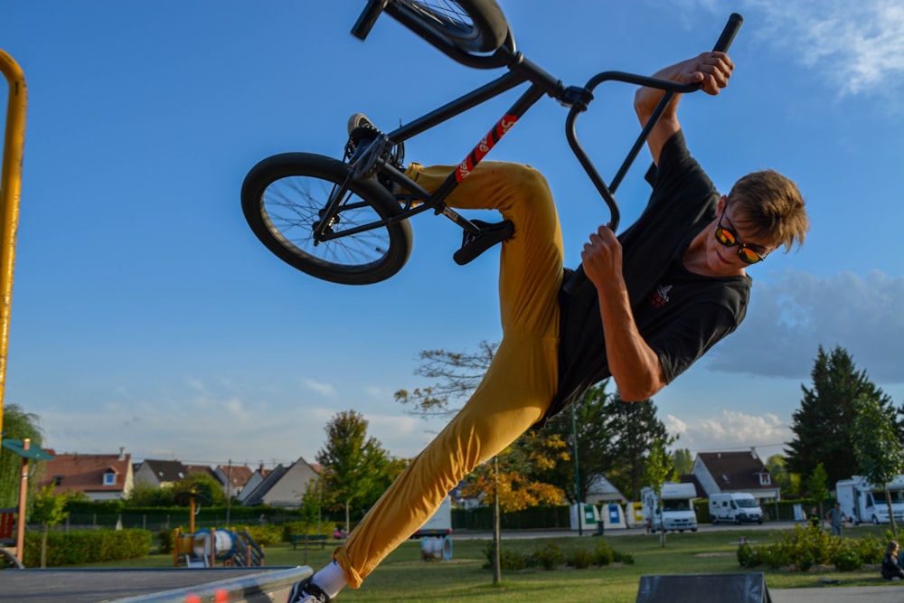 a man doing a trick on a bicycle