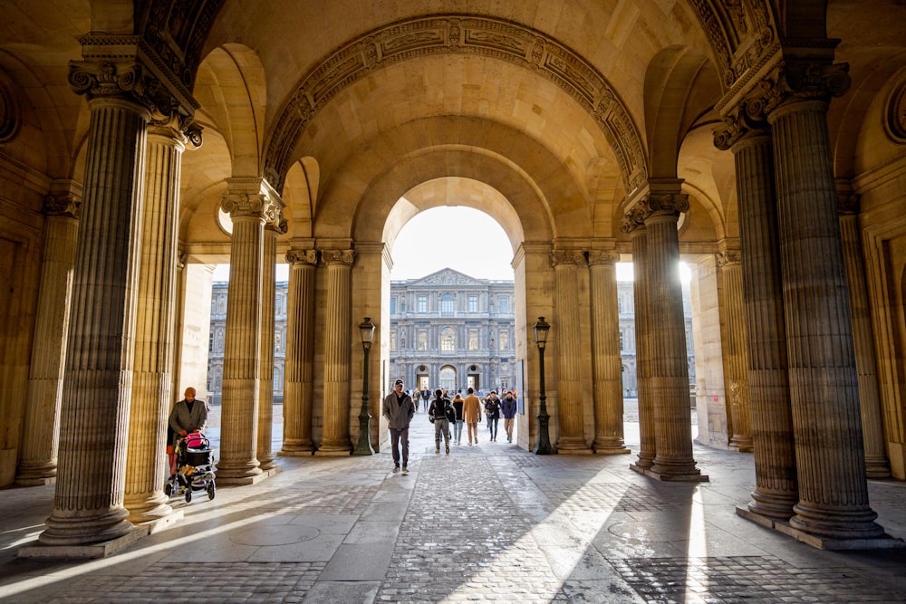 a large building with many arches and people walking around