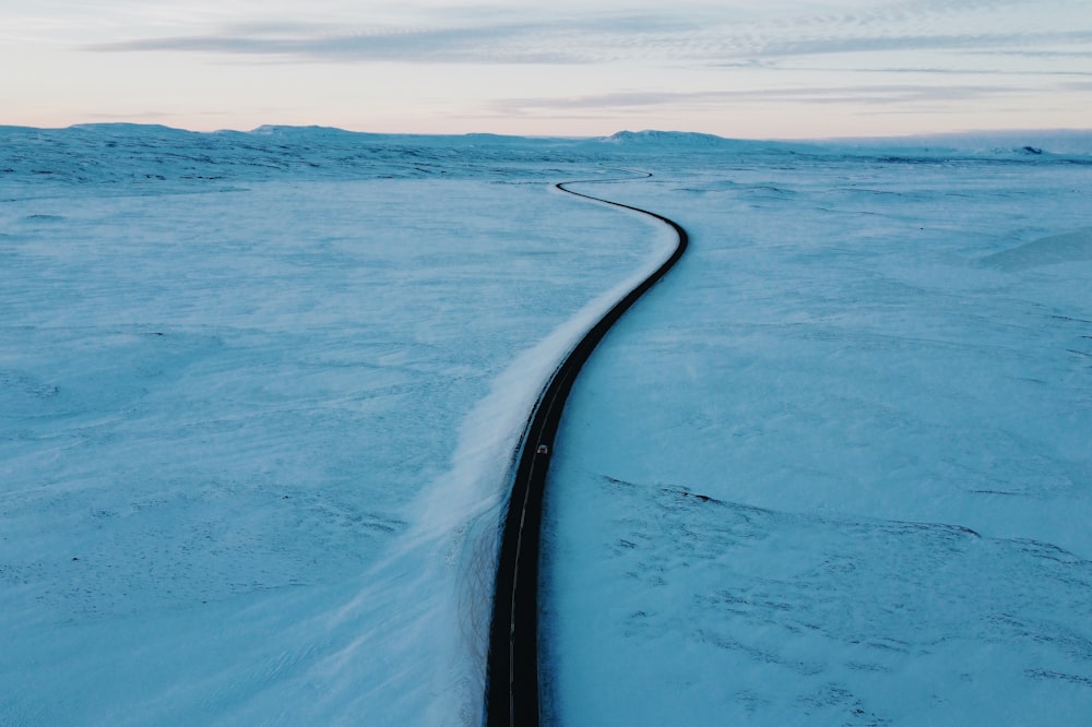a long straight road in the snow