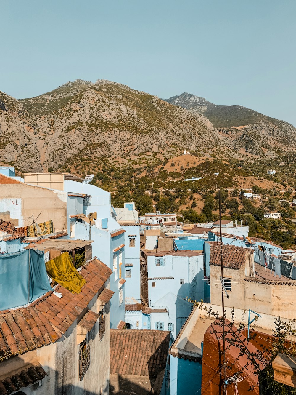 a group of buildings with mountains in the background