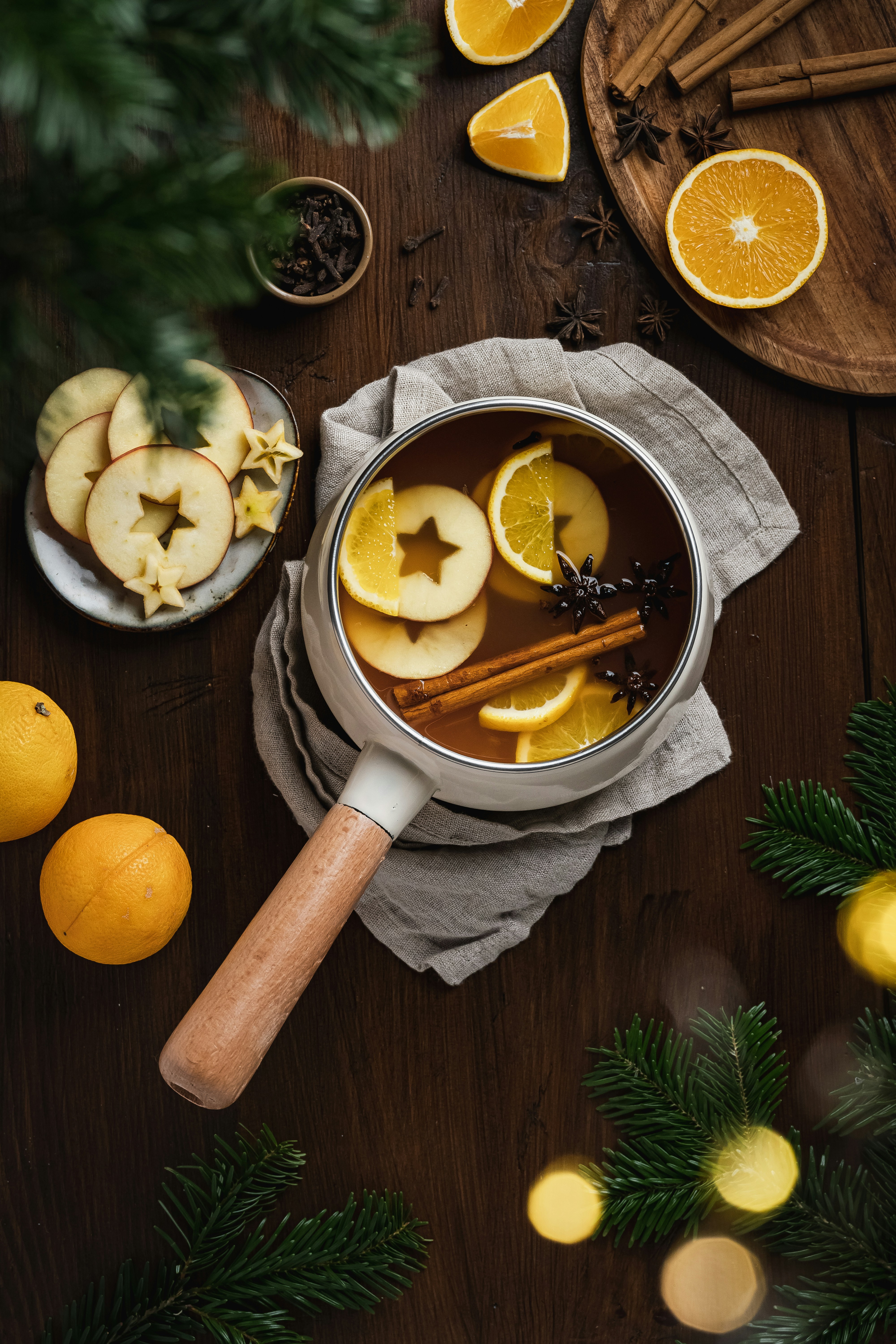 a wooden spoon with lemons and a bowl of sliced lemons