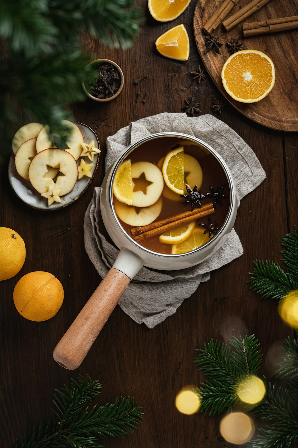 a wooden spoon with lemons and a bowl of sliced lemons