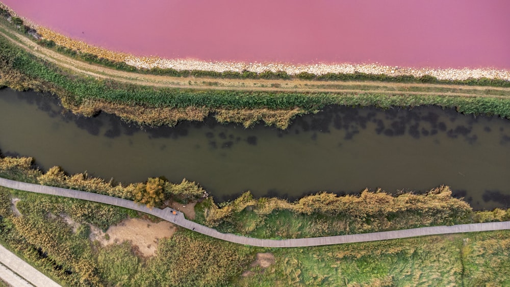 a river with a fence and grass