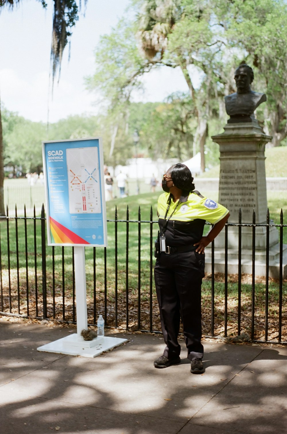 a police officer standing next to a sign