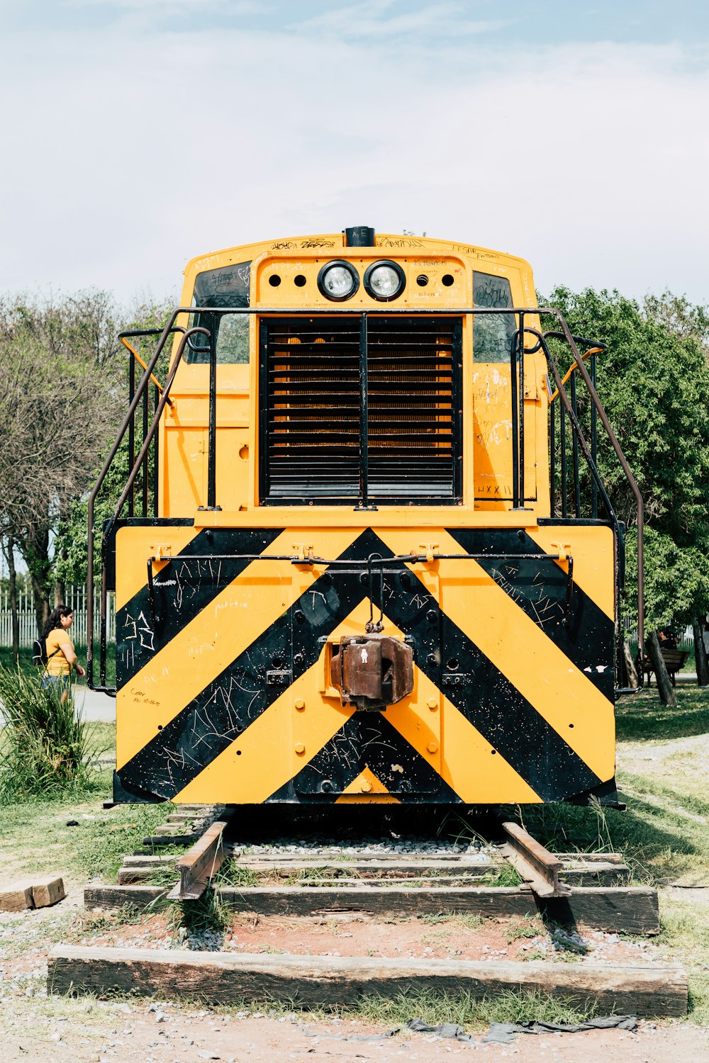 a yellow train on the tracks