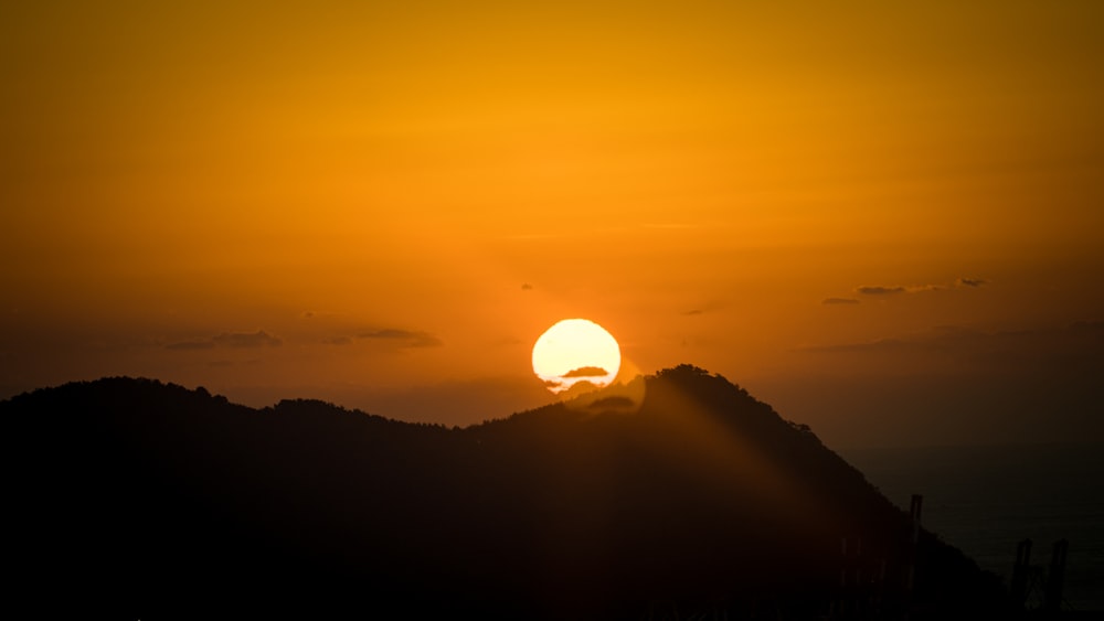 a sunset over a mountain