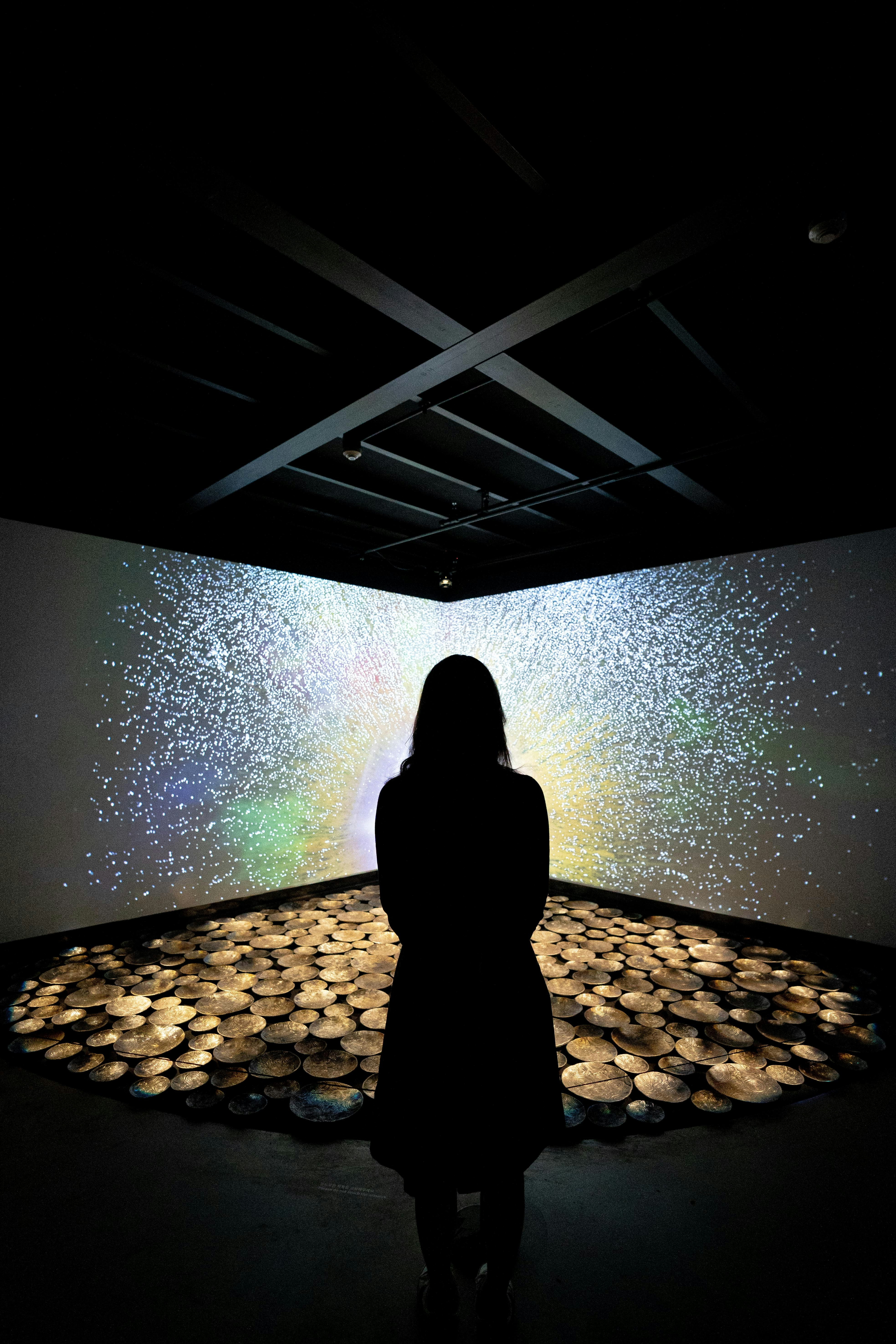 a person standing in front of a large water fountain