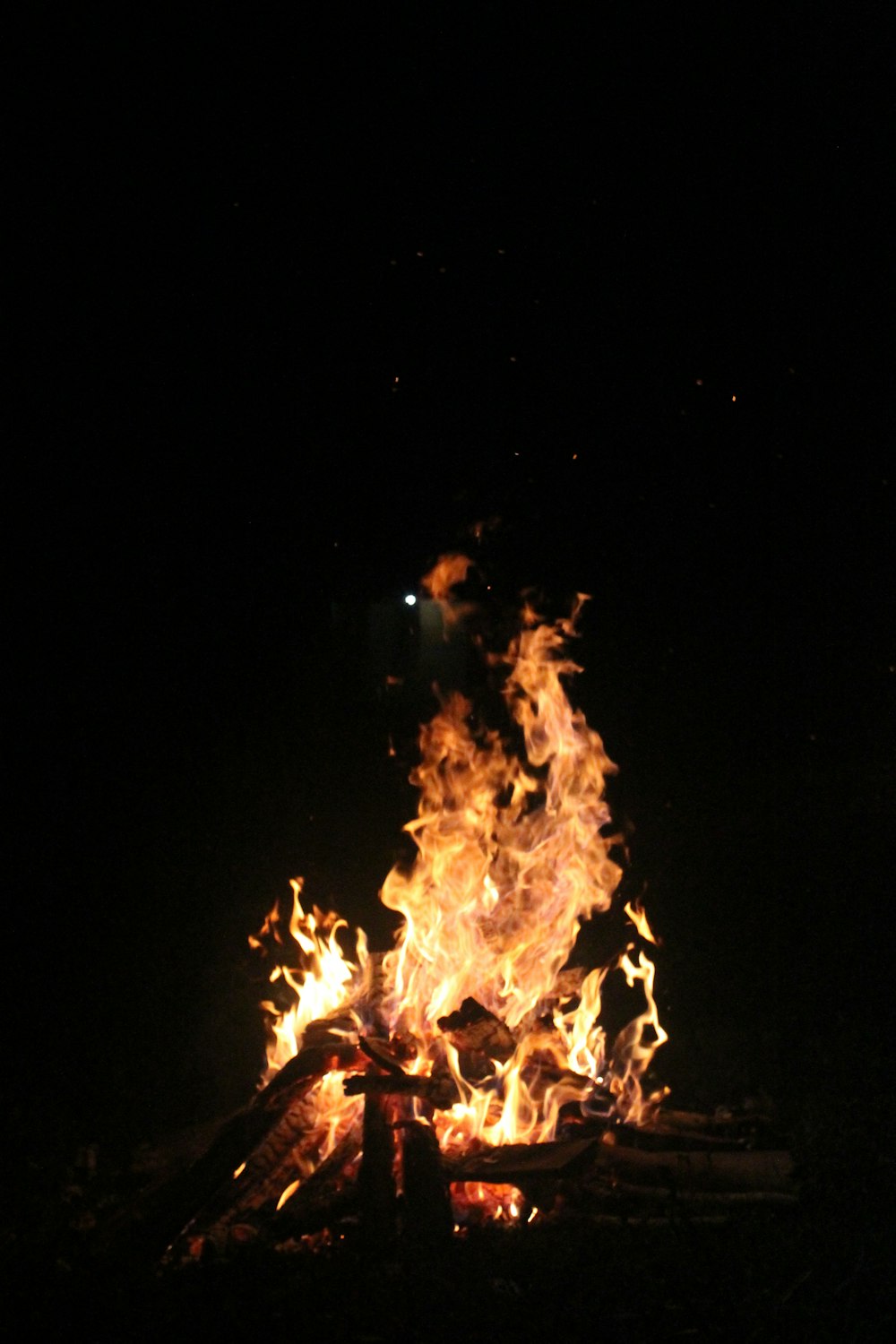 a bonfire at night with Bonfires of Saint John in the background