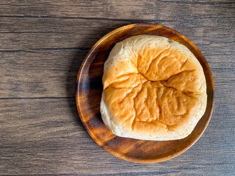 a round brown pastry on a wooden surface