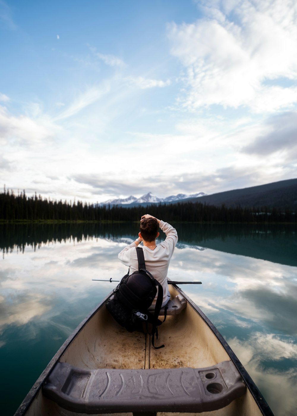 a person and a dog on a boat in a lake