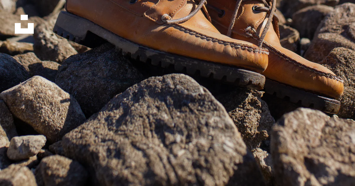 Shoes With Rocks Inside A pair of shoes on rocks by water photo – Free Usa Image on Unsplash