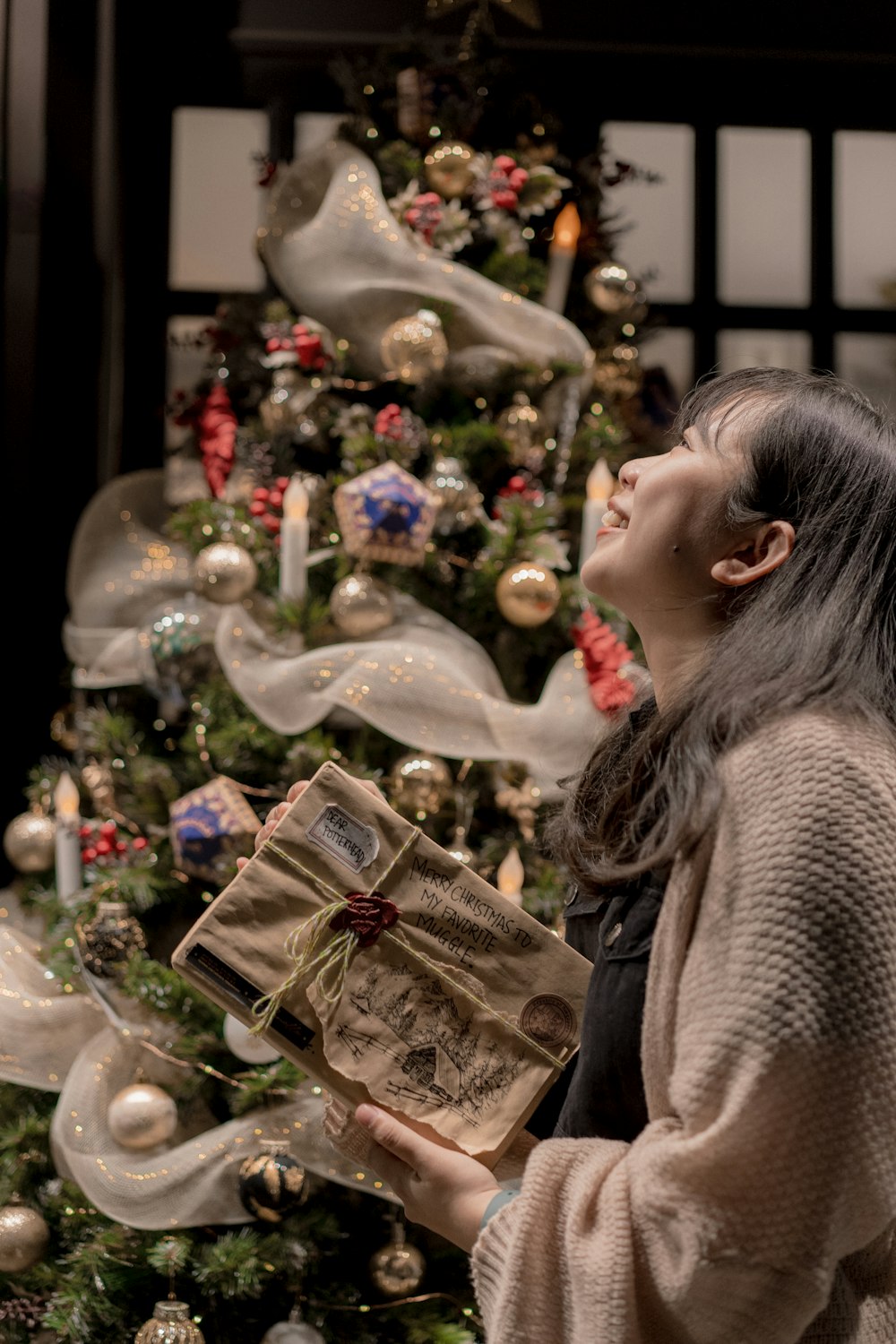 a woman kissing a christmas tree