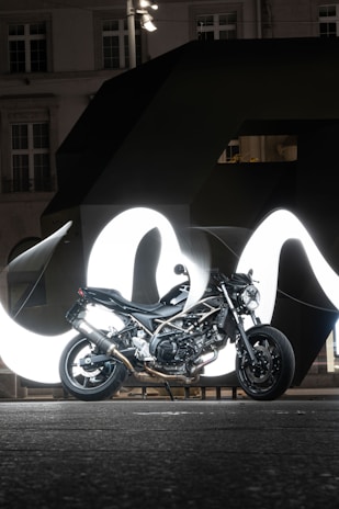 A powerful motorbike parked against an urban backdrop.