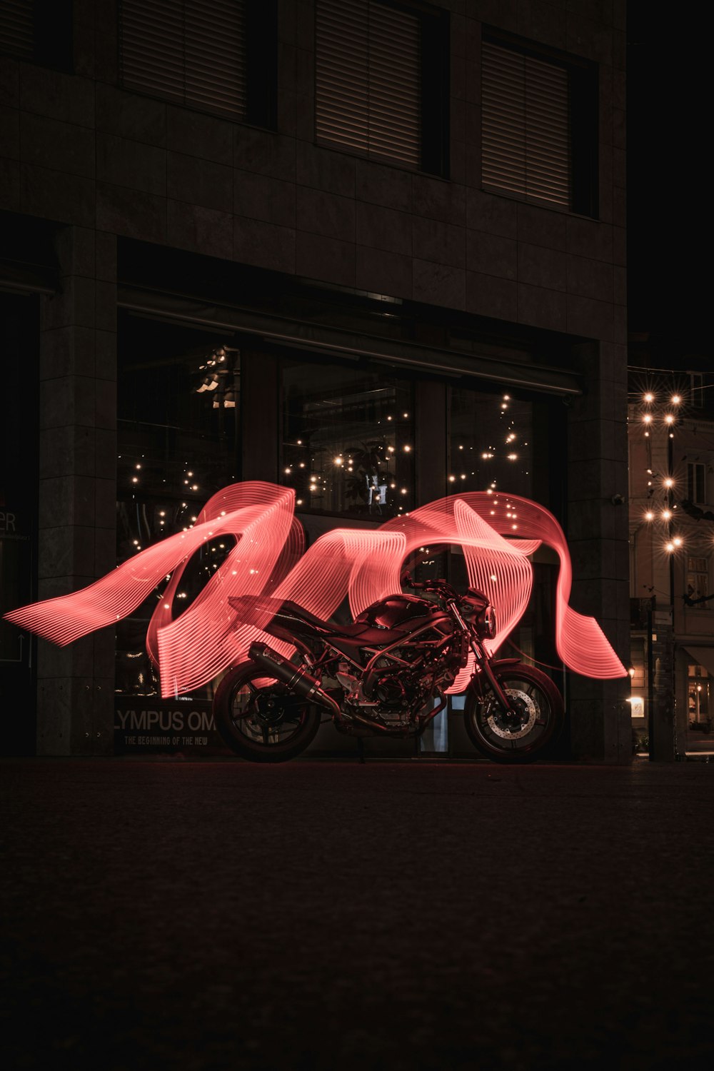 a pink motorcycle with a pink hood